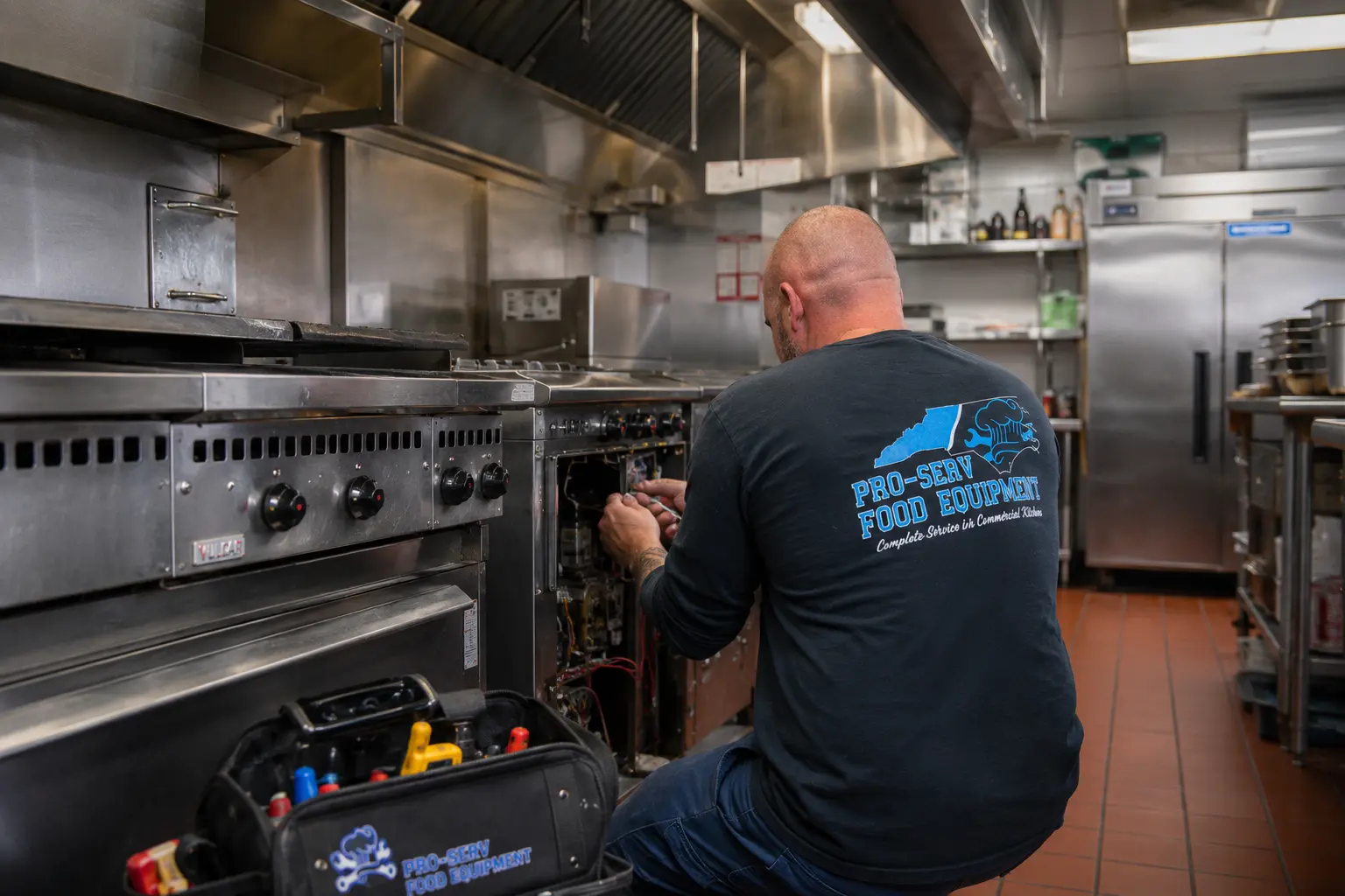 Pro-Serv Food Equipment technician repairing commercial cooking equipment in a professional kitchen in New Bern, NC
